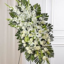 Tall white floral standing spray with palm fronds