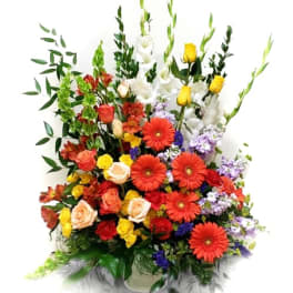 Colorful mixed bouquet with roses, gerbera daisies, and white gladiolus