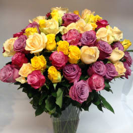 Mixed-color rose bouquet in a clear glass vase