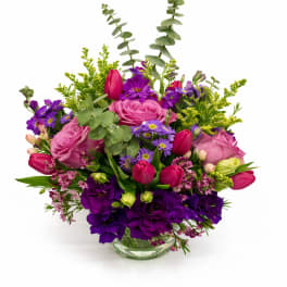 Pink and purple mixed bouquet in a clear glass vase