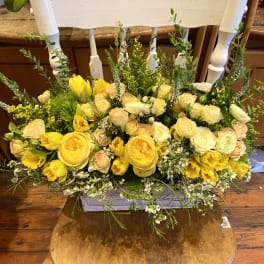 Yellow and cream floral arrangement on a chair