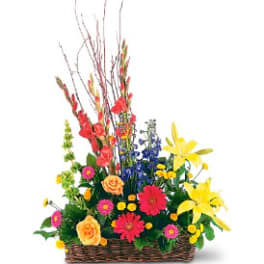 Colorful mixed flower arrangement in a wicker basket