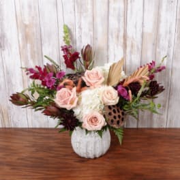 Pink roses and white hydrangea in a white pumpkin vase with burgundy accents
