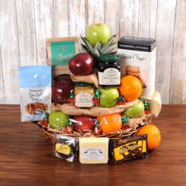 Gift basket filled with assorted fresh fruit, gourmet snacks, jars, cheese, and chocolates