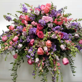 Large bouquet of pink and purple roses with trailing flowers