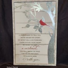 Framed memorial sign with a red cardinal on a tree branch and a sympathy poem