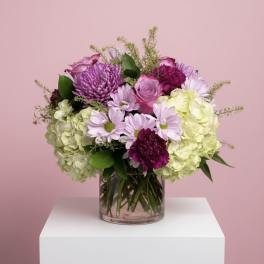 Mixed pink and purple bouquet in a clear glass vase