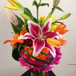 Bright bouquet of lilies and roses in a glass vase