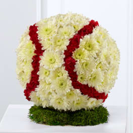 Round floral arrangement of white and red chrysanthemums on a green base