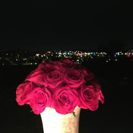 Bouquet of bright pink roses in a white vase