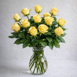 Yellow roses arranged in a clear glass vase
