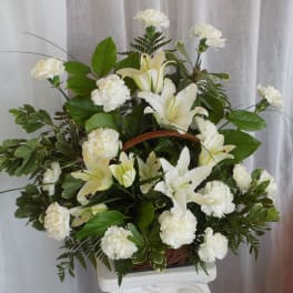 White lilies and carnations in a pedestal arrangement