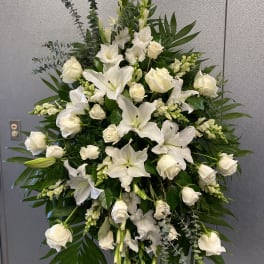 Large white floral standing spray with roses and lilies