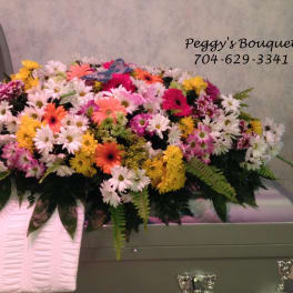 Colorful mixed flower casket spray with daisies and gerbera daisies