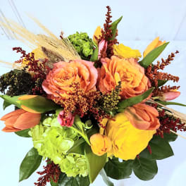 Bouquet of orange roses, yellow tulips, and green hydrangeas