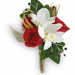 Red and white floral boutonniere with green leaves and gold ribbon