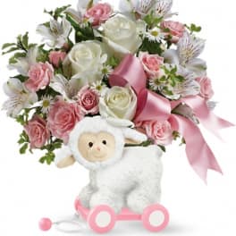 Pink and white rose bouquet with a plush lamb toy