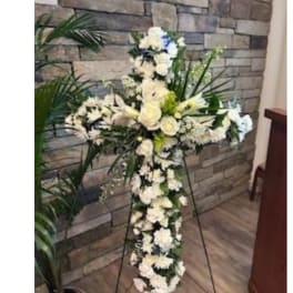 White floral standing cross on an easel