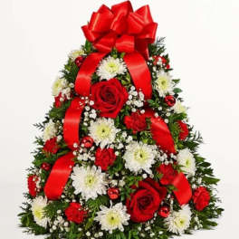 Christmas tree-shaped floral arrangement with red roses, white daisies, and a red bow