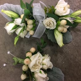 White floral corsage and boutonniere with ribbon and pearl accents