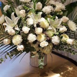 White floral arrangement with roses, lilies, and chrysanthemums in a vase
