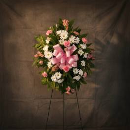 Pink and white floral standing wreath with a pink ribbon bow