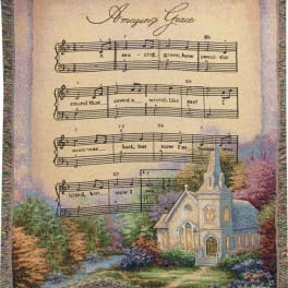 Decorative throw blanket with hymn lyrics and a church scene