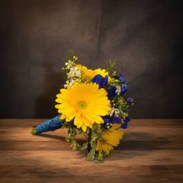 Yellow gerbera bouquet with blue flowers and white filler