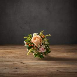 Small bouquet of peach and pink roses with white filler flowers