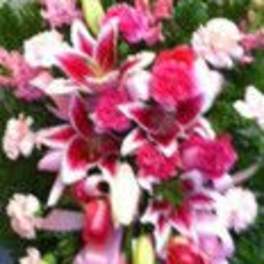 Pink and white floral spray with lilies and carnations