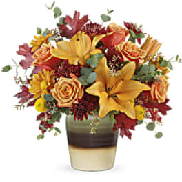 Autumn bouquet of yellow lilies and roses in a striped vase