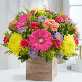 Colorful mixed flower arrangement in a wooden box