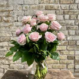 Pink roses arranged in a clear glass vase