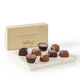Box of assorted chocolates on a marble tray