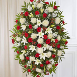 Standing floral spray with red roses, white lilies, and white chrysanthemums