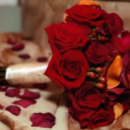 Bouquet of red roses with orange calla lilies