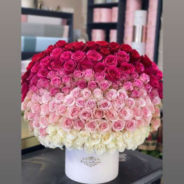 Large ombré bouquet of pink and red roses in a white hat box