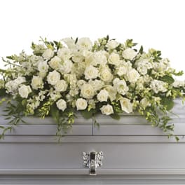 White floral casket spray with roses and calla lilies