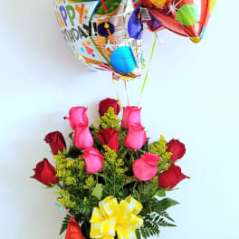 Birthday balloon bouquet with roses and a teddy bear in a vase