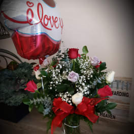 Bouquet of red and white roses with a heart balloon