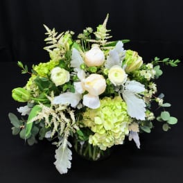 Round white centerpiece with soft green grey