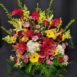 Large mixed bouquet with red lilies, yellow daisies, and pink roses