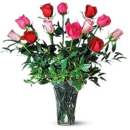 Bouquet of red and pink roses in a clear glass vase