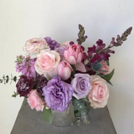 Pink and lavender floral arrangement in a silver vase