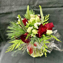 Bouquet of red and white roses with green accents in clear wrap