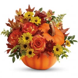 Pumpkin-shaped floral arrangement with orange roses and yellow daisies