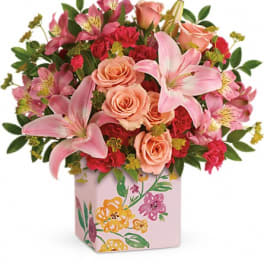 Pink lilies and roses in a floral-painted vase