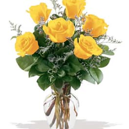 Yellow roses arranged in a clear glass vase