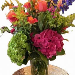 Colorful mixed flower arrangement in a clear glass vase