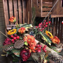 Autumn floral arrangement with orange blooms, berries, pinecones, and fish accents